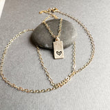 Petite gold stamped heart necklace