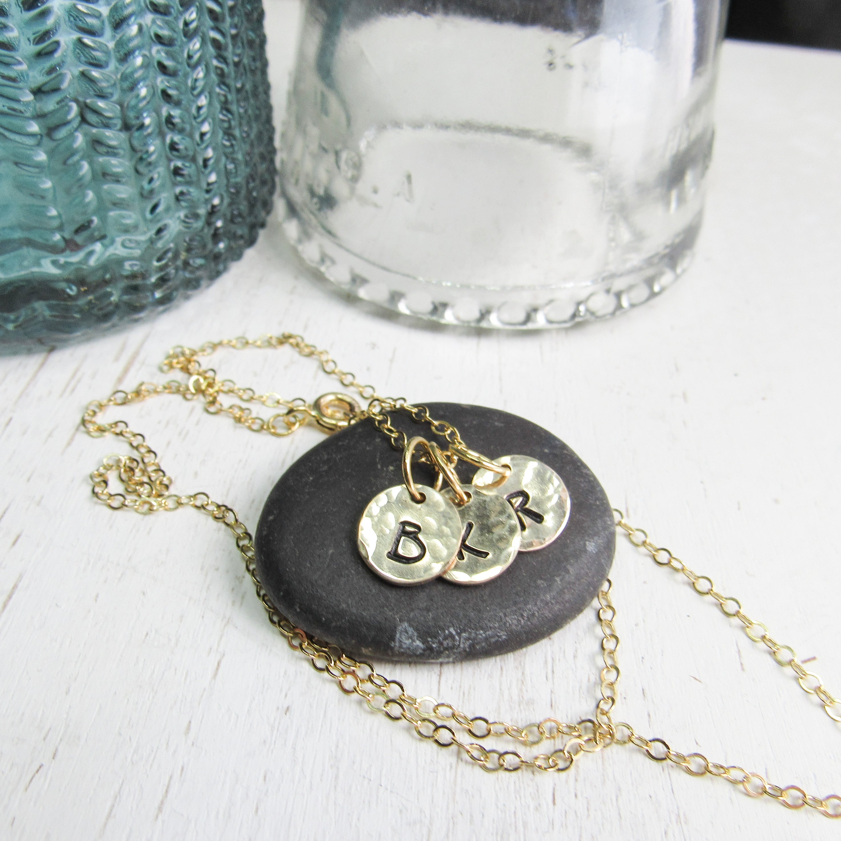 14K Gold filled keepsake charm necklace. Small charms are textured and stamped with the letters that mean the most to your heart. 