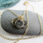 14K Gold filled keepsake charm necklace. Small charms are textured and stamped with the letters that mean the most to your heart. 